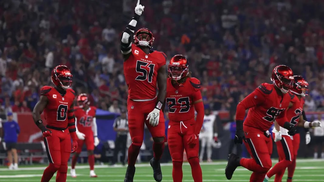 Texans defensive players celebrate after sacking Josh Allen