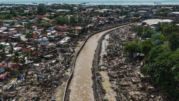 Aerial view of Typhoon Kalmaegi destruction in Cebu, Philippines showing flooded residential area with collapsed homes and rescue operations amid devastation
