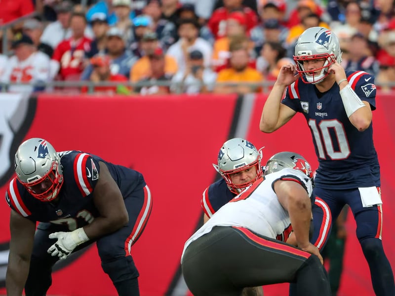 Drake Maye MVP Contender Patriots 2025 Drake Maye throwing touchdown pass for New England Patriots in 2025 MVP campaign