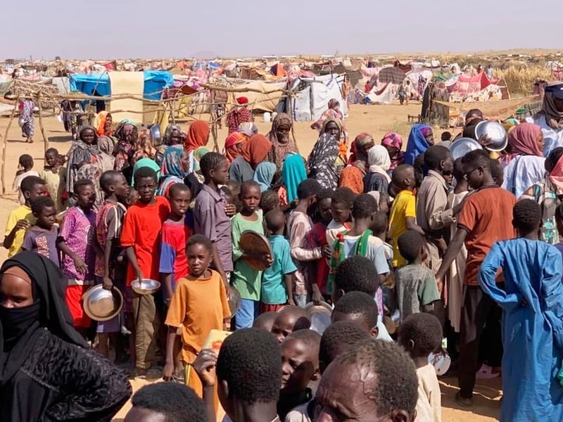 Sudanese children walking through refugee camp near El Fasher