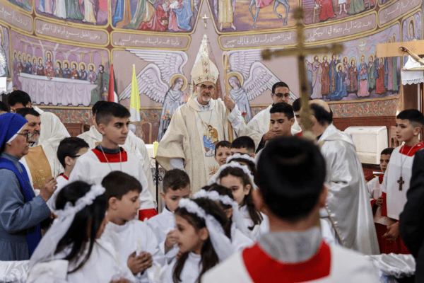 Palestinian Christians pray at Holy Family Church in Gaza amid rubble on Christmas Day 2025 during day 750 of Israeli genocide
