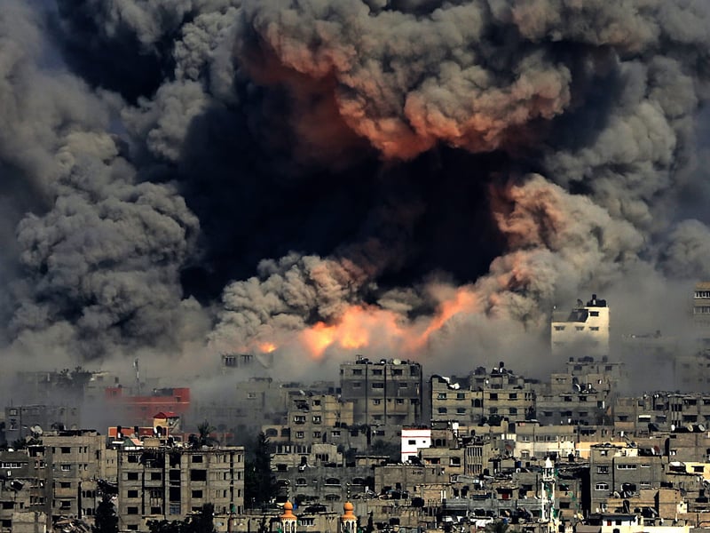 Aerial view of Gaza city showing destruction and smoke during Israeli attacks