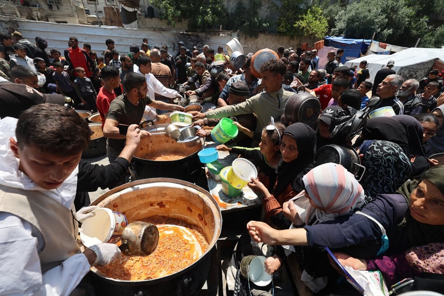Palestinians queue for scarce food amid aid blockade in Gaza