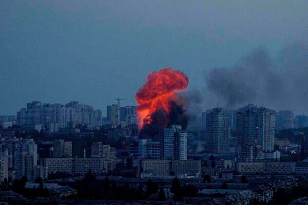 Kyiv skyline showing smoke and damaged buildings during winter Russia Ukraine war