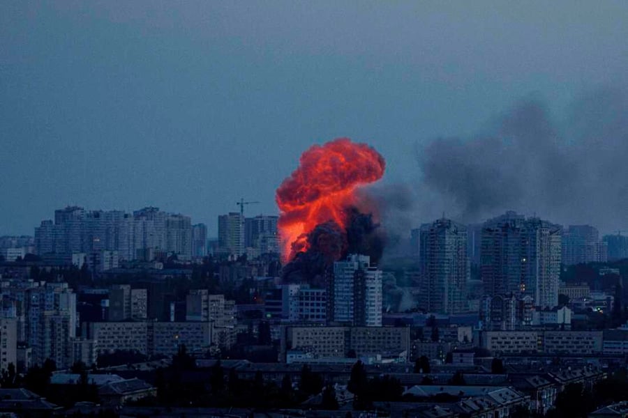 Kyiv skyline showing smoke and damaged buildings during winter Russia Ukraine war