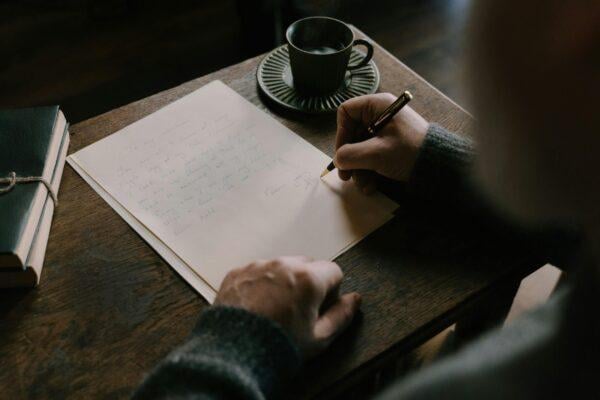 A writer sits at a quiet desk practicing mindfulness to improve focus and overcome creative anxiety while writing