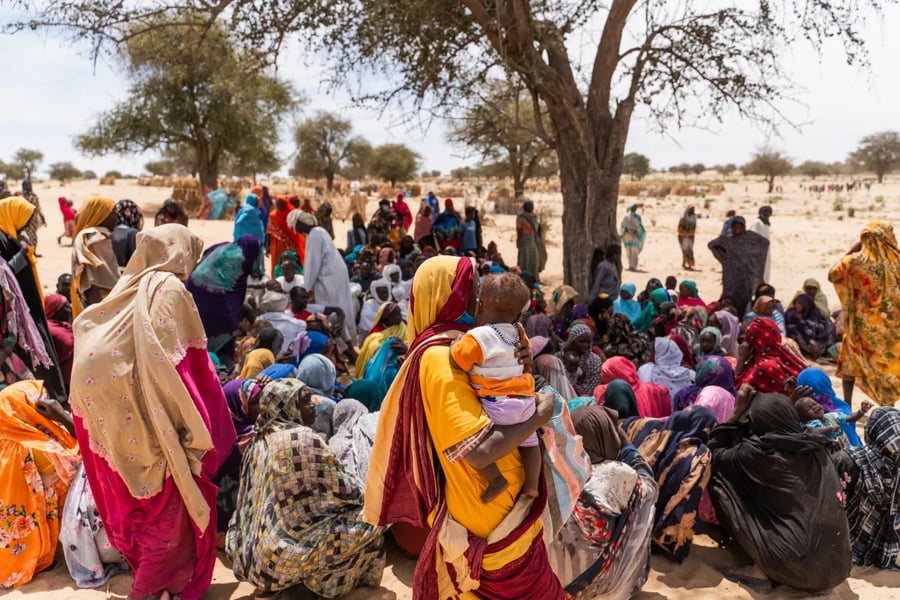 Displaced Sudanese families shelter under makeshift sheets in Kosti as fighting spreads.