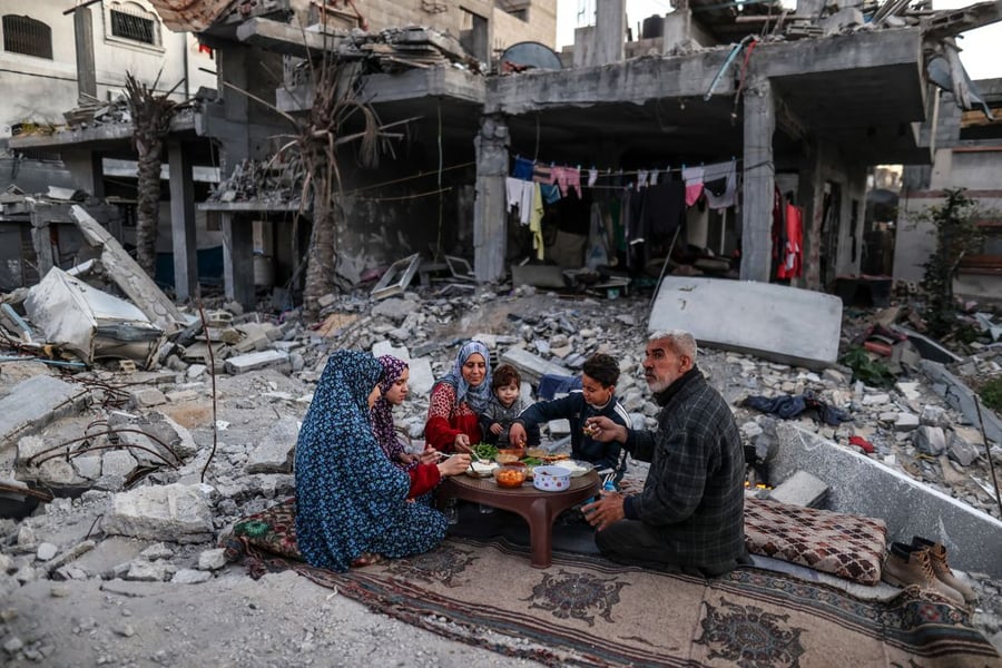 Palestinian family breaking fast in a destroyed home in Gaza during Ramadan