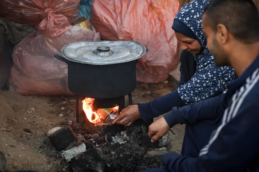 Gaza Families Forced to Cook Over Wood Palestinian family cooks over wood fire in Gaza due to cooking gas shortage