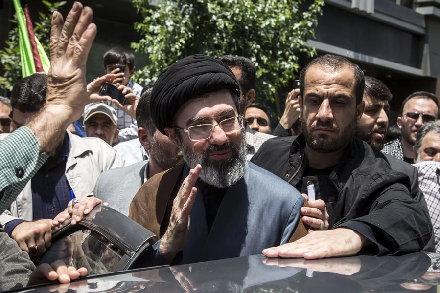 Mojtaba Khamenei standing in Tehran political gathering