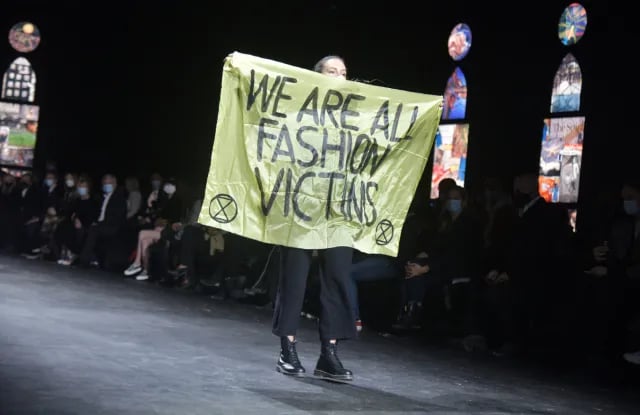 Activists protest on runway highlighting fashion industry sustainability crisis