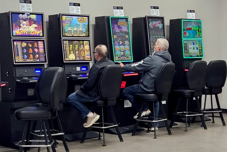 Players using slot machines inside a US casino environment