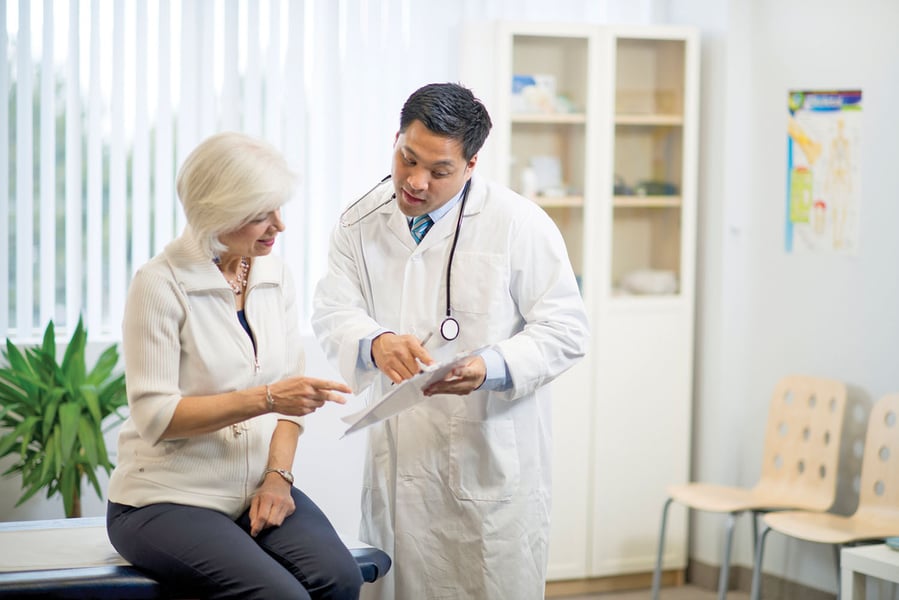 Oncologist consulting cancer patient in hospital