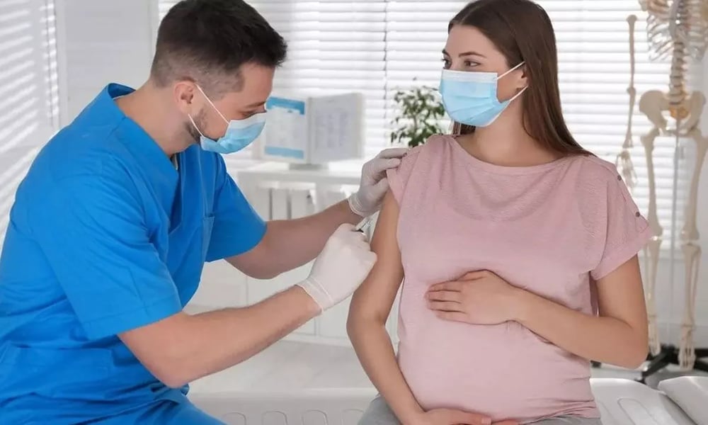 Pregnant woman receiving RSV vaccine consultation showing infant protection through maternal antibodies