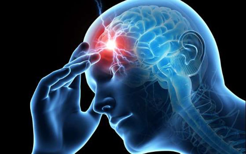 Person experiencing a migraine headache holding their head in pain
