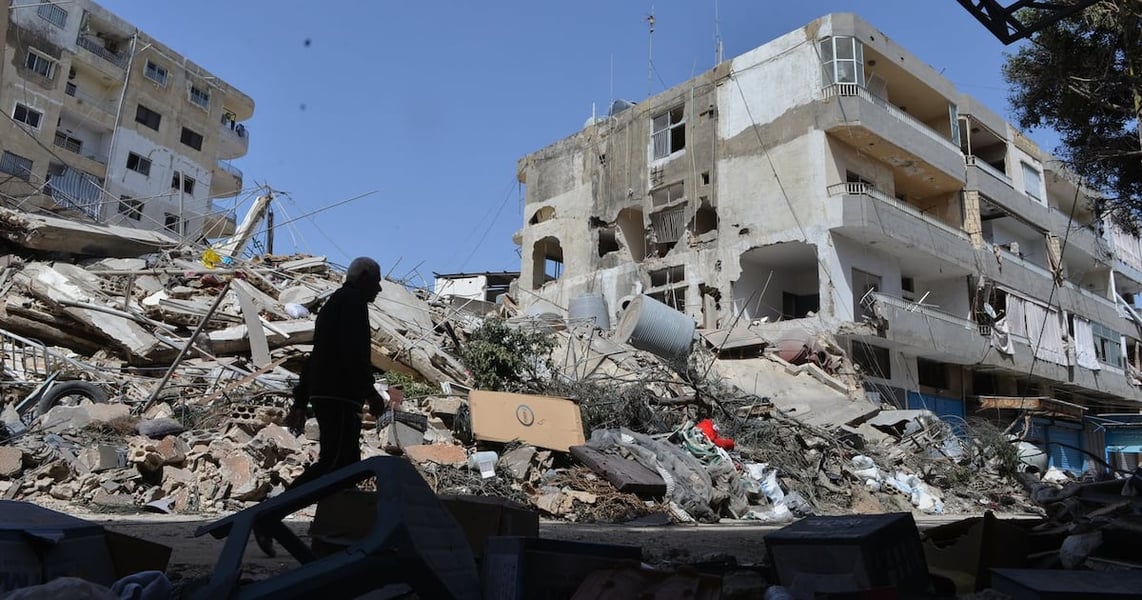 A man walks next to buildings destroyed by Israeli airstrikes in the southern Lebanese village of Maarakeh, May 2026