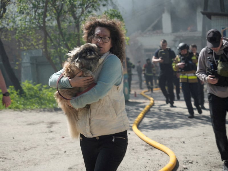 Emergency workers at the site of a Russian strike in Kharkiv, Ukraine