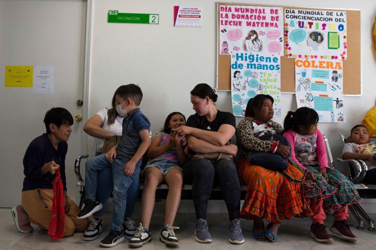 Health worker administering MMR measles vaccine to child in Cuauhtemoc Mexico amid 2026 outbreak