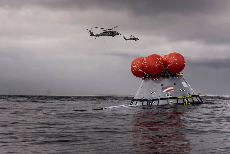 NASA recovery teams retrieving Orion capsule in Pacific Ocean after splashdown