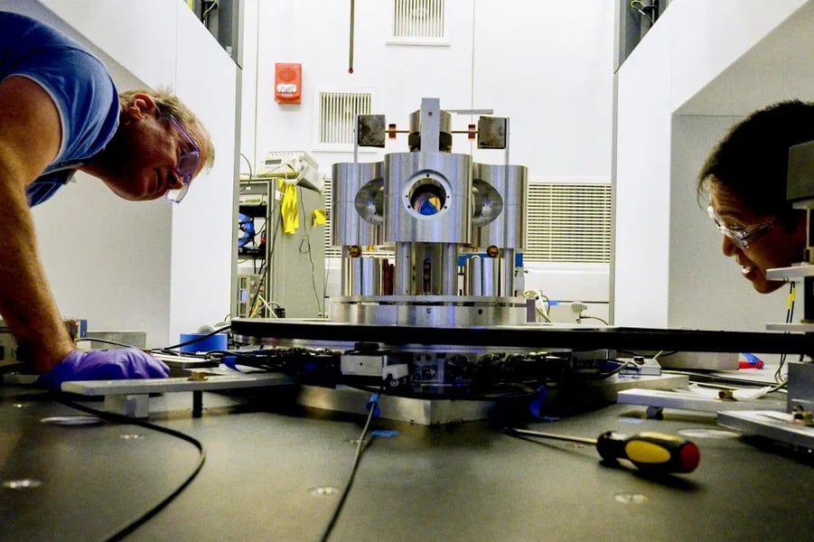 NIST physicist Stephan Schlamminger examines the torsion balance used to measure the gravitational constant Big G