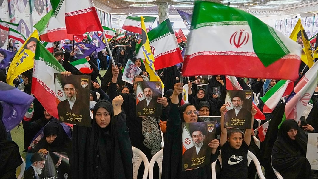 Iranian flags and portraits at a ceremony as US strikes and IRGC retaliation push oil prices higher