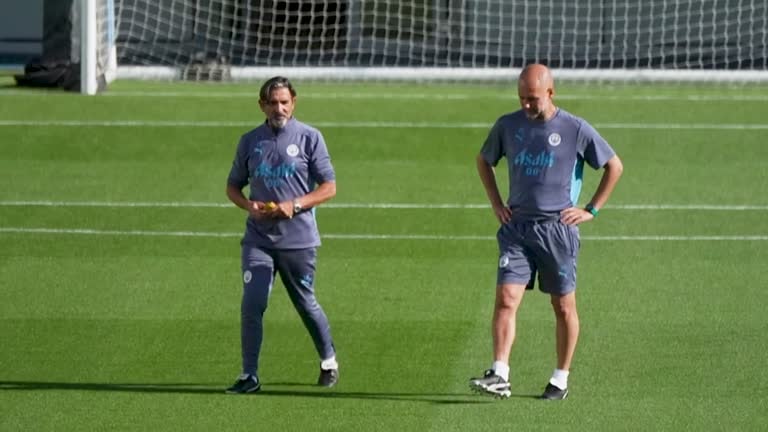 Guardiola's Coaching Influence at Manchester City Pep Guardiola gives instructions during Manchester City training