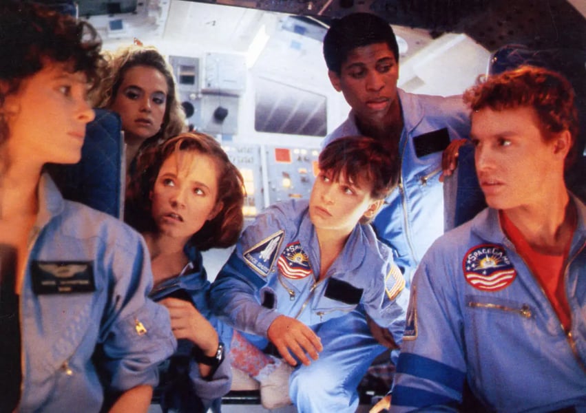 SpaceCamp 1986 film theatrical poster featuring Lea Thompson Joaquin Phoenix and cast in NASA jumpsuits