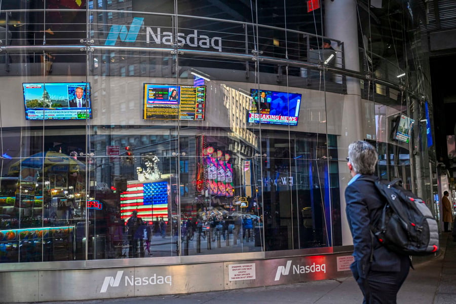 Donald Trump displayed on screens at the New York Stock Exchange during controversy over massive stock trade disclosures