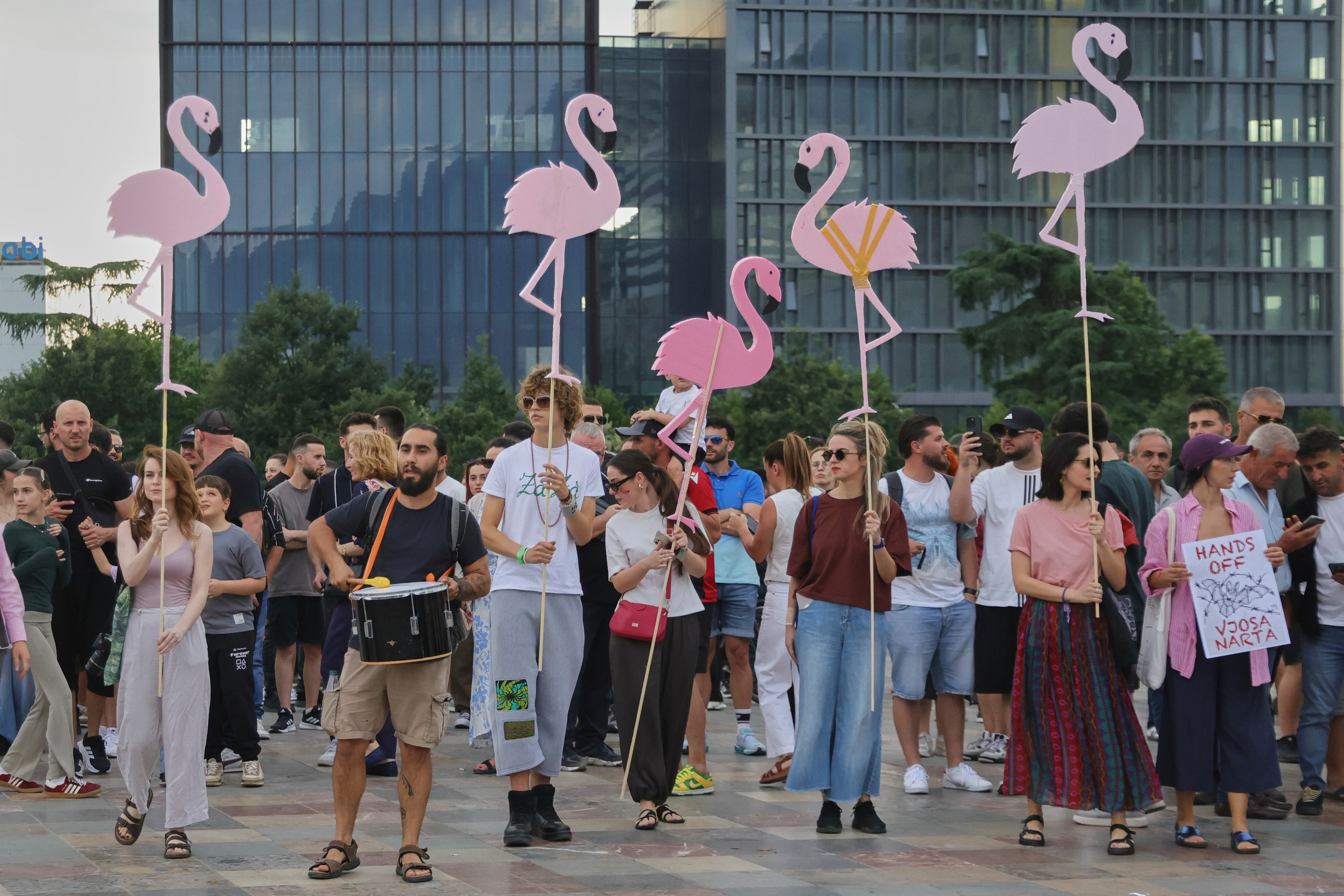 Protesters hold pink flamingo cutouts during a demonstration in Tirana against the Kushner resort