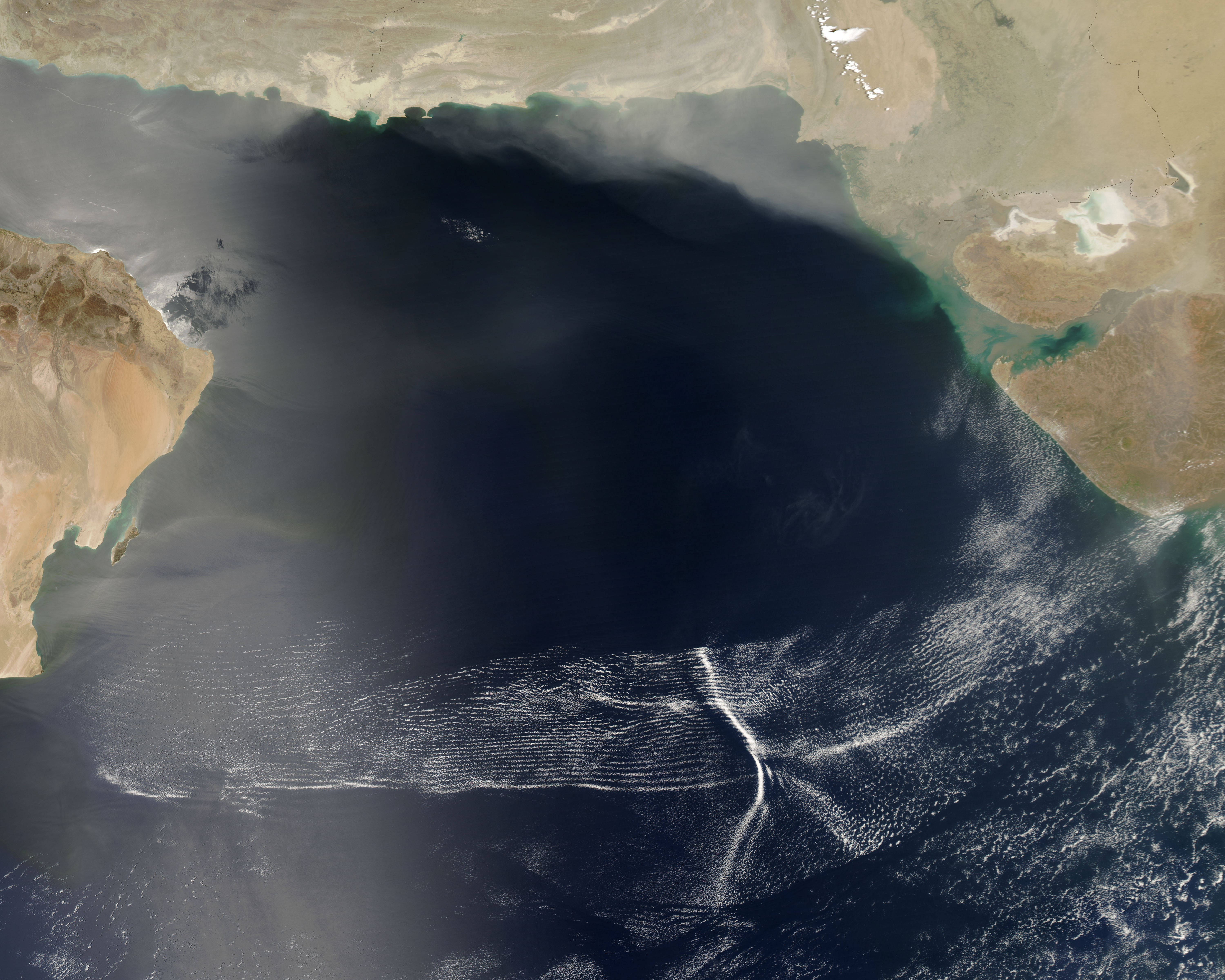 NASA MODIS satellite image from the Aqua satellite showing a massive cluster of wave clouds spanning the Arabian Sea from Oman to western India during a monsoon system advance