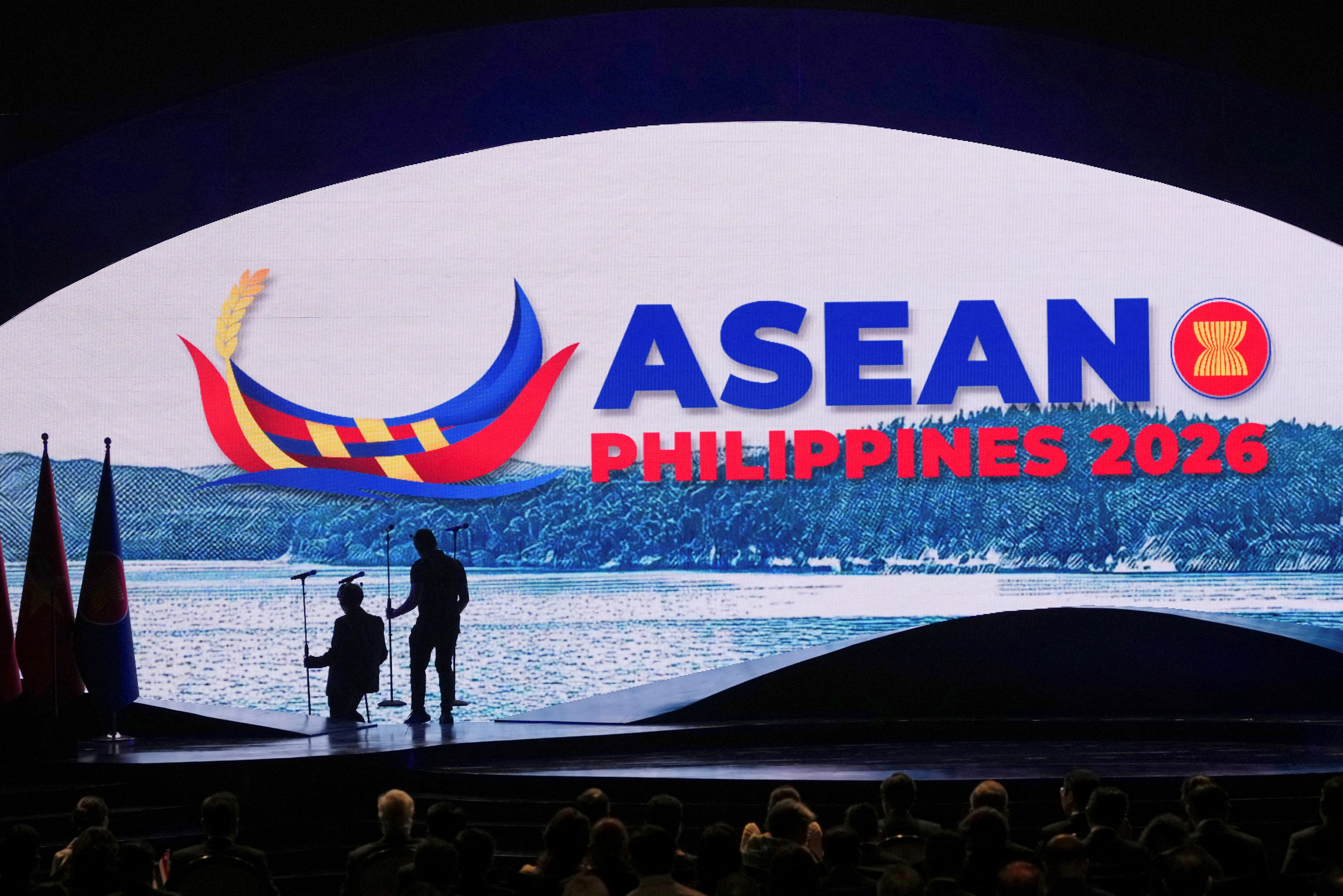 Workers arrange microphones at the ASEAN summit opening ceremony in Cebu, Philippines, as leaders prepare to meet Putin in Kazan