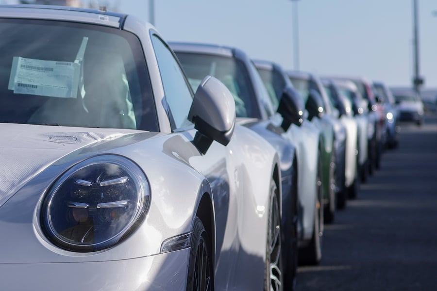 Rows of vehicles awaiting export shipment at a port facility