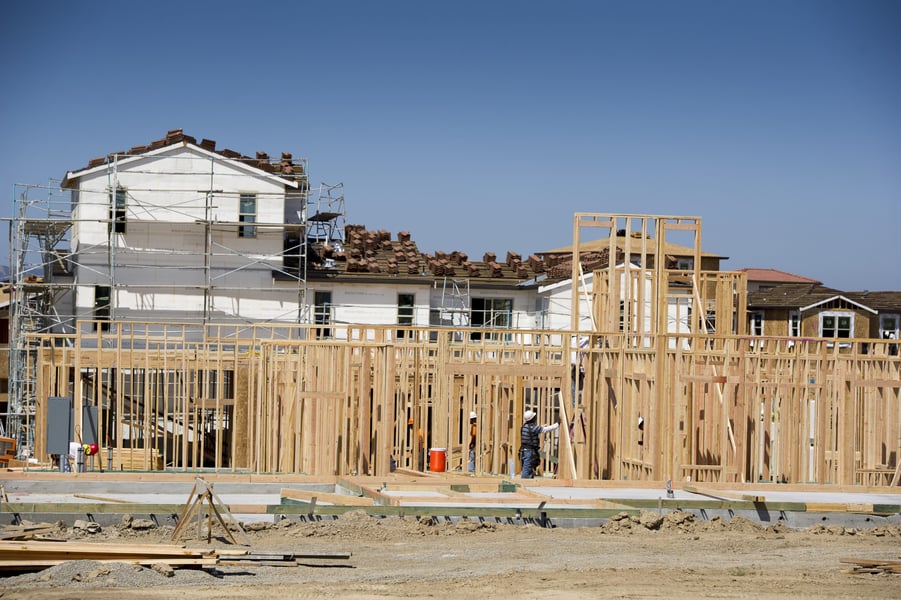 Contractors build a new home at Taylor Morrison La Solara community in Dublin California