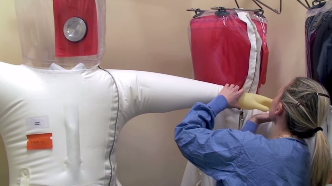 A scientist in a positive-pressure protective suit at a high-containment biosafety laboratory