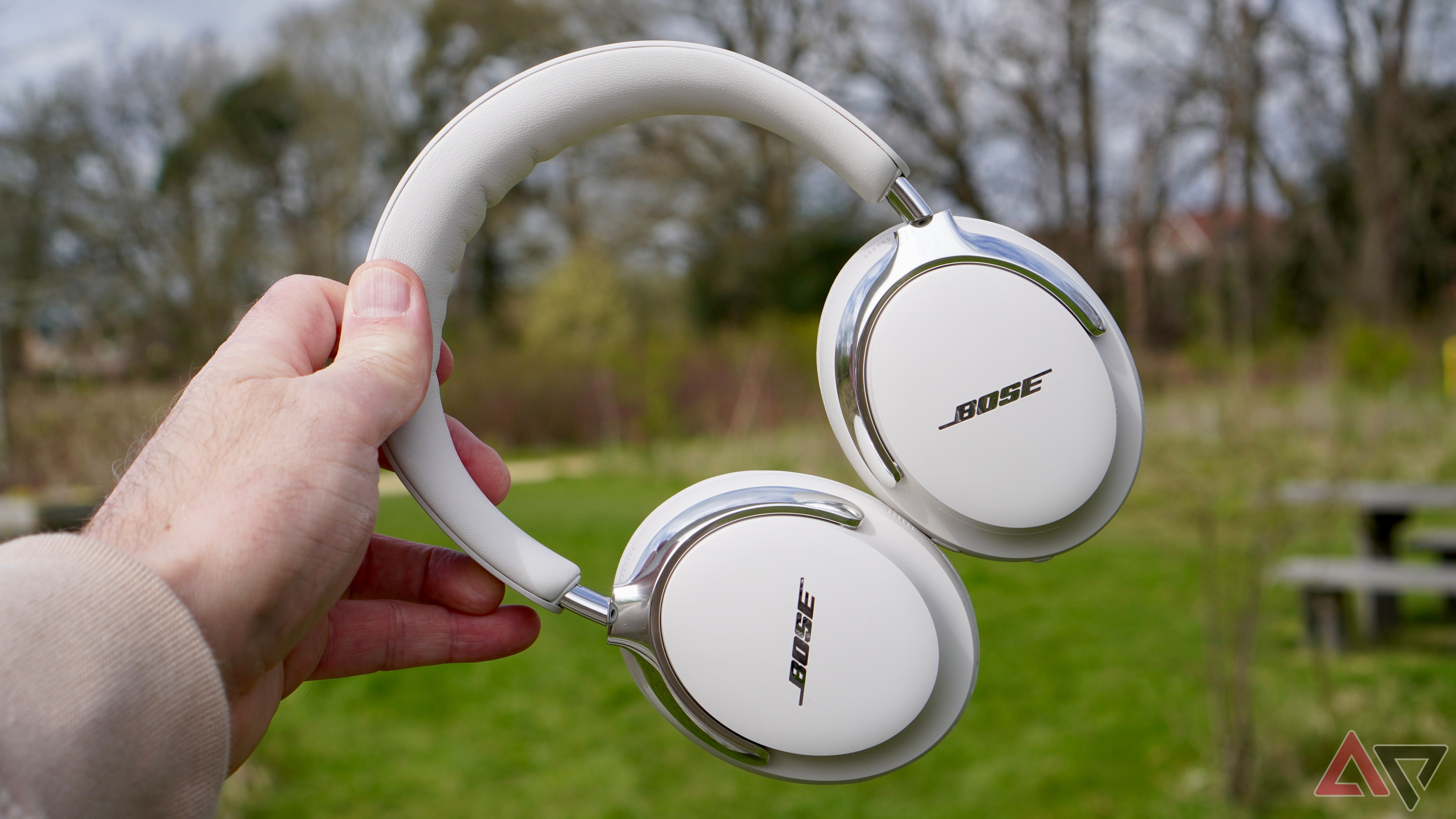 Person holding Bose QuietComfort Ultra 2nd Gen headphones showing premium build quality
