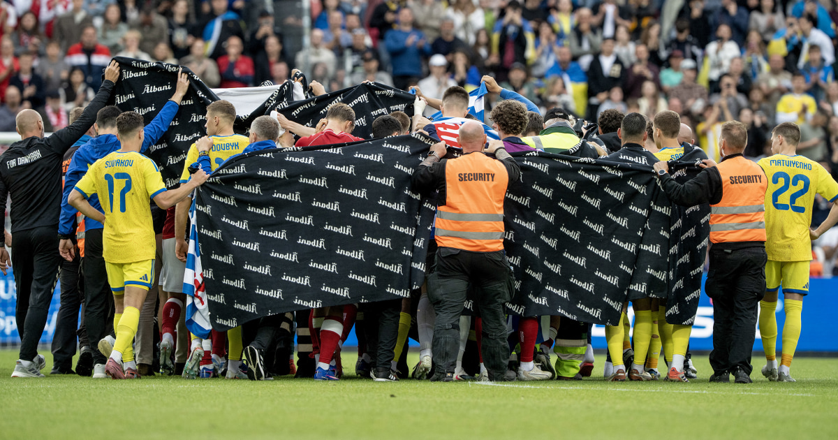 Denmark and Ukraine players surrounding Christian Eriksen after he collapsed at Nature Energy Park Odense June 2026