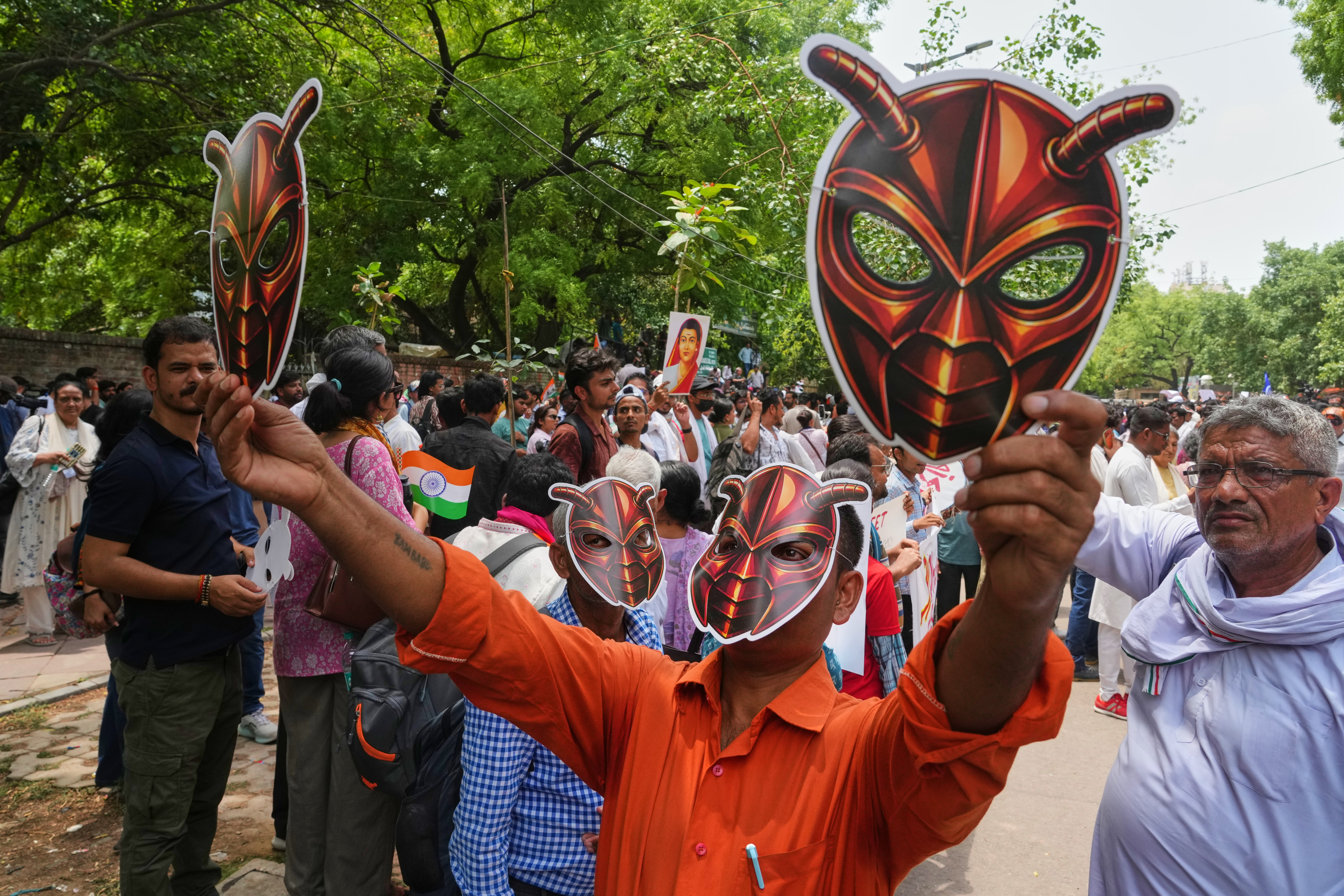 Protesters wearing cockroach masks near India's parliament during the rally against exam system failures