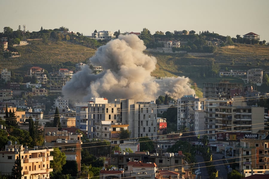 Residents search through debris inside a damaged building in Dahieh, Beirut's southern suburbs, following an Israeli airstrike on a Hezbollah command center
