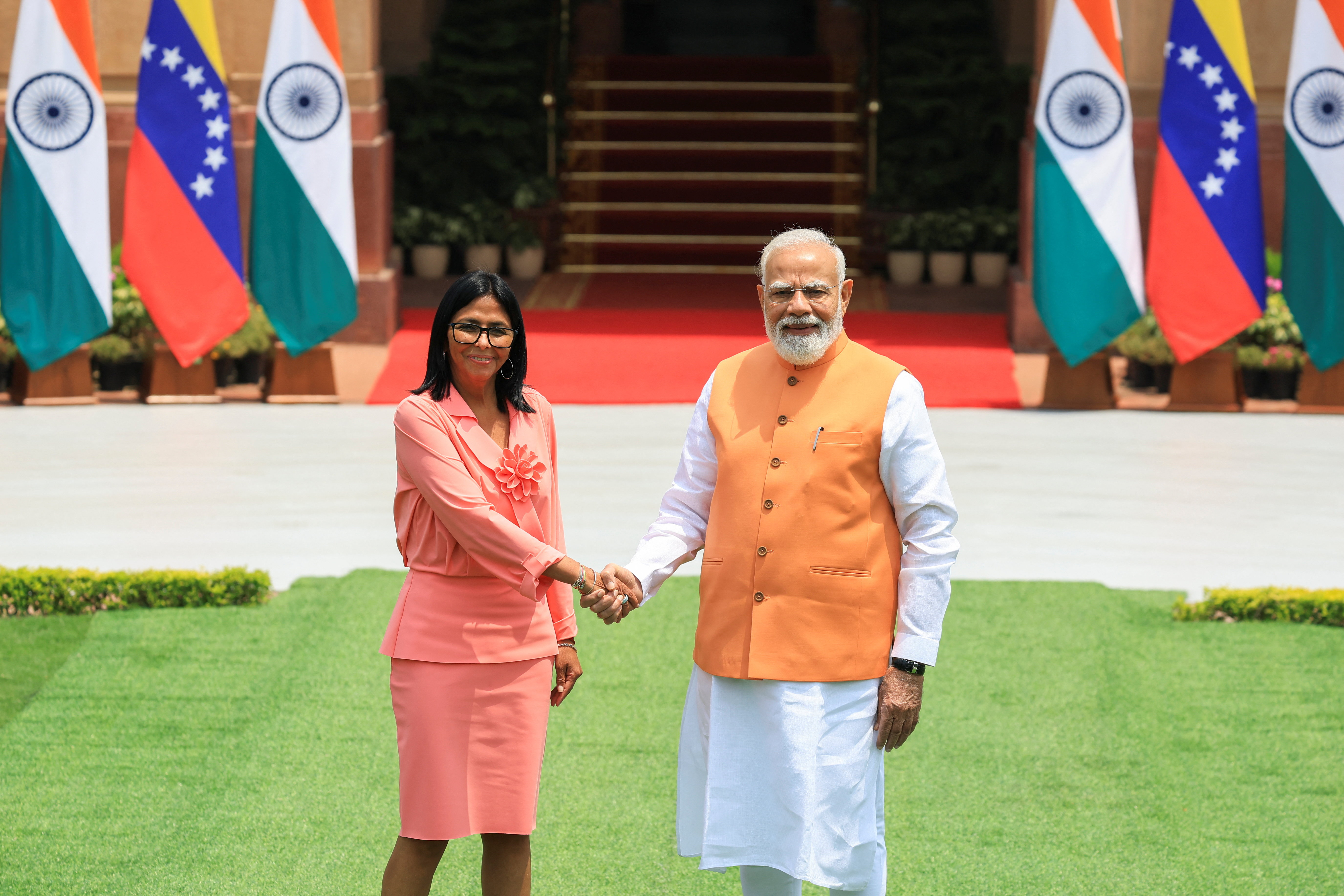Venezuela's acting President Delcy Rodriguez shakes hands with India's Prime Minister Narendra Modi