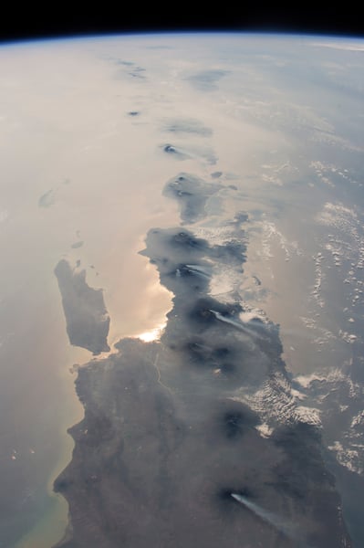 NASA astronaut photograph from the International Space Station showing nearly half the length of Indonesia's main island chain with Java Bali Lombok Sumba and Timor visible against the Indian Ocean