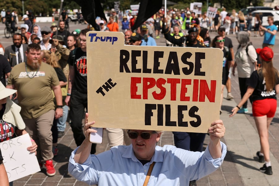 Protester holds sign saying Release the Epstein Files at a demonstration in Washington DC