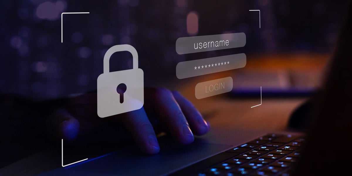 Person entering login credentials on a laptop illustrating password manager vulnerability risks
