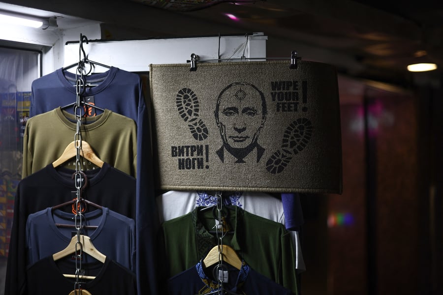 A doormat featuring Russian President Vladimir Putin outside a shop in Kyiv, Ukraine, on the four-year anniversary of Russia's military operation