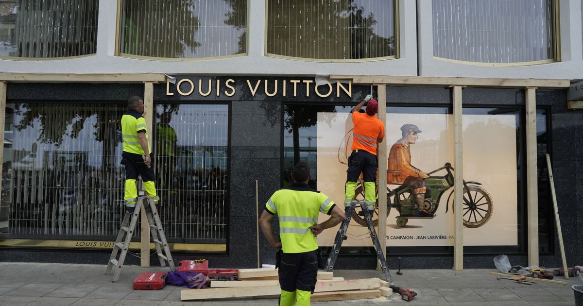 Construction workers board up a Geneva shop window ahead of expected protests before the G7 summit in Evian-les-Bains June 2026