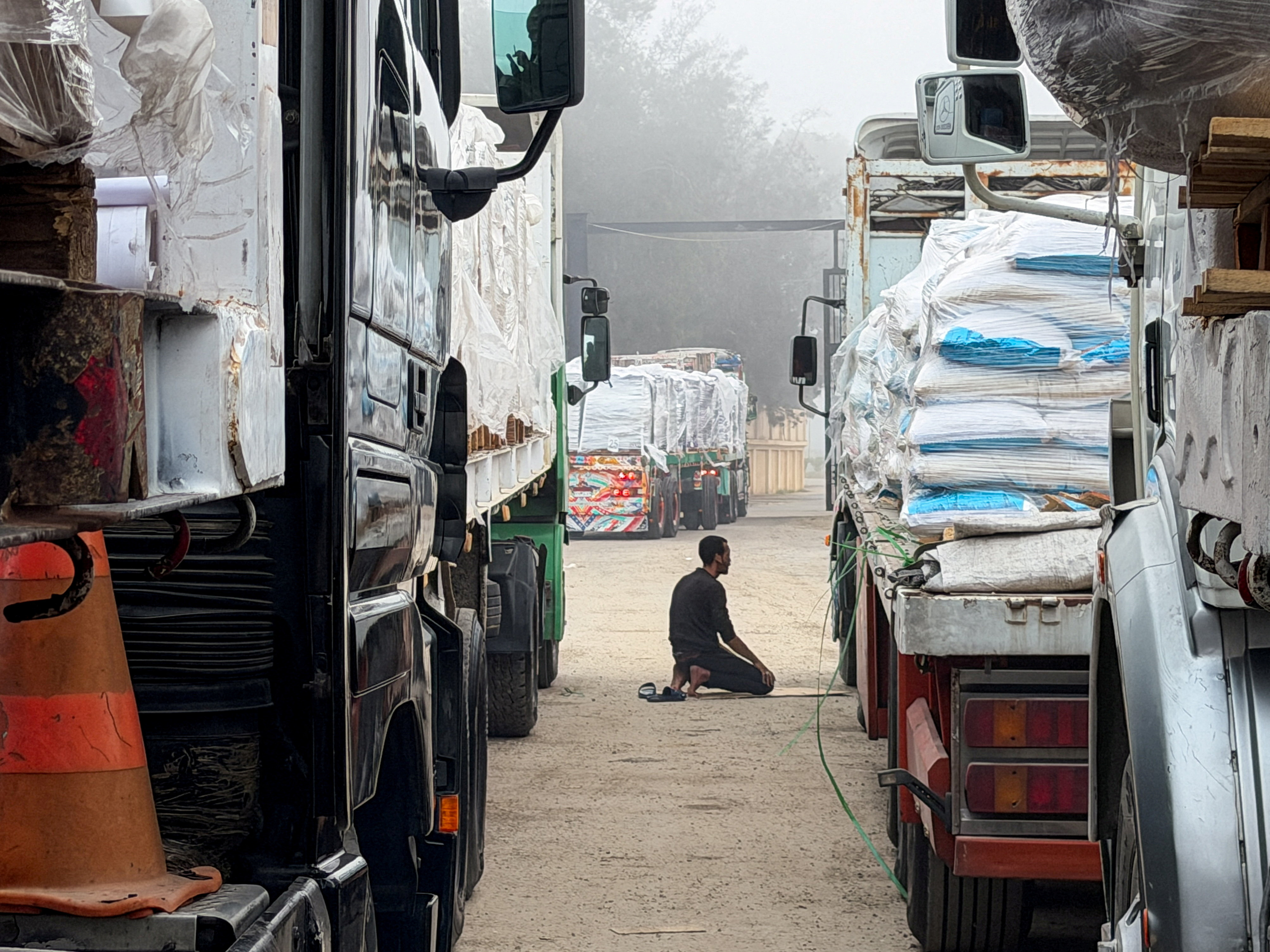 Trucks carrying humanitarian aid lined up at the Rafah border crossing into Gaza