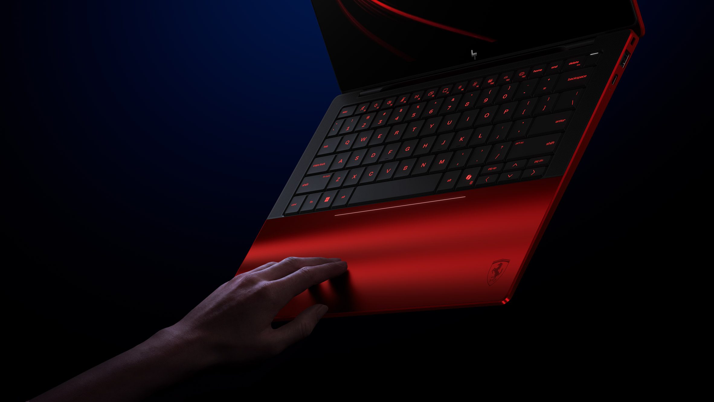 HP Scuderia Ferrari AI PC showing invisible haptic trackpad with backlit indicator line