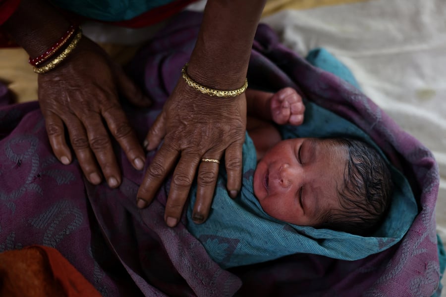 A nurse cares for a newborn baby at a hospital in Kishanganj district of Bihar, the Indian state with the highest fertility rate