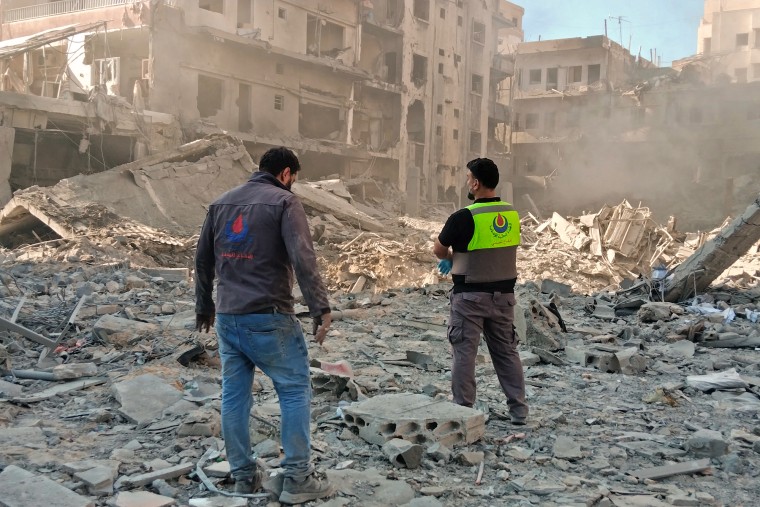 Civil defense workers inspect rubble from Israeli strike in southern Lebanon as Iran suspends US ceasefire talks