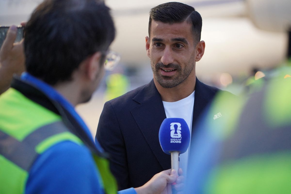 Iran captain Ehsan Hajsafi speaks to reporters as the national team arrives for the 2026 World Cup