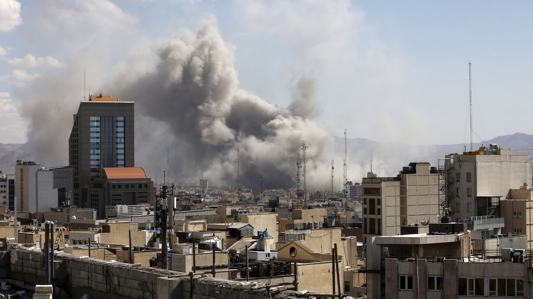 Smoke plume rising over buildings in Tehran following Israeli airstrikes on June 8 2026